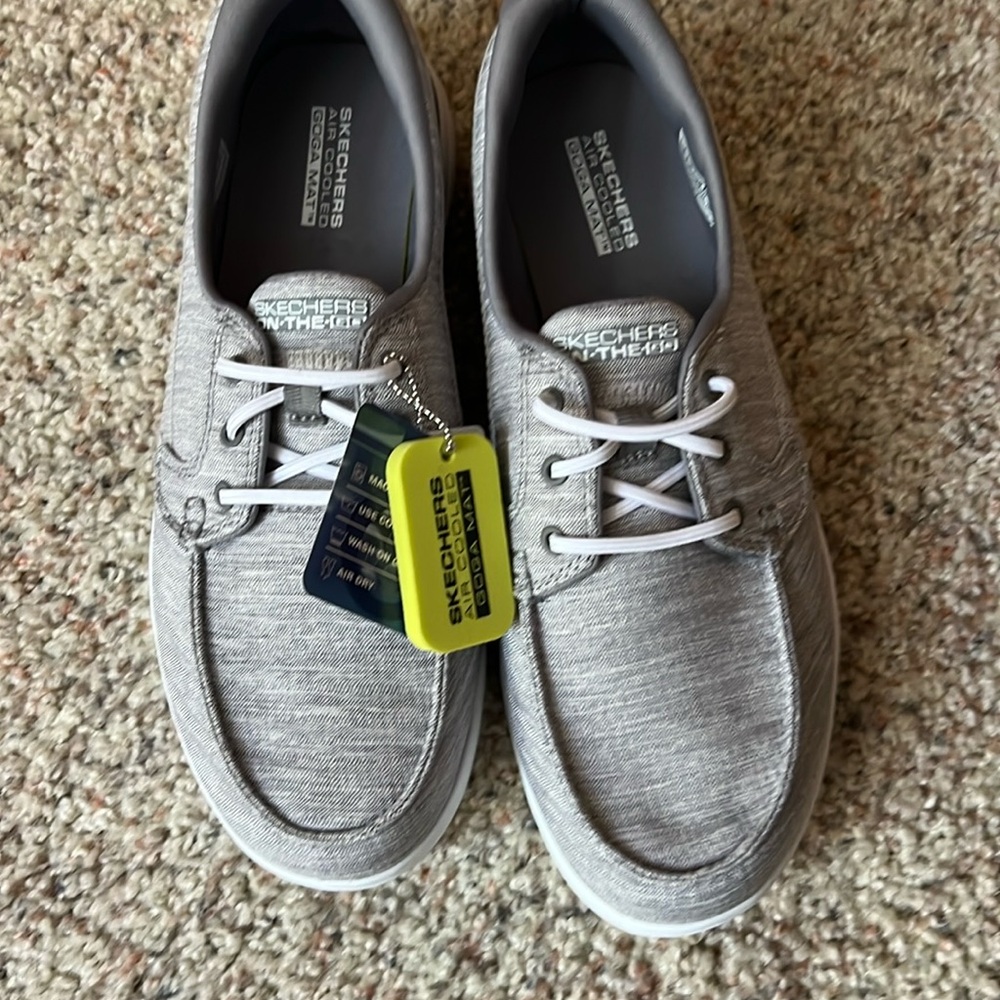 Sketchers, never worn with tags. Comfort shoe. Light gray. Size 8.
